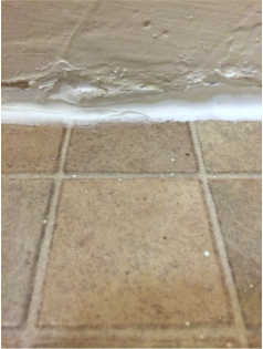 Caulked gap in the bottom of wall