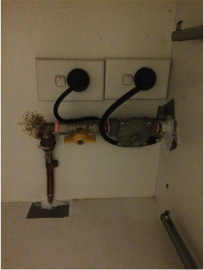 Taped and caulked gas pipe penetrations in cabinet.